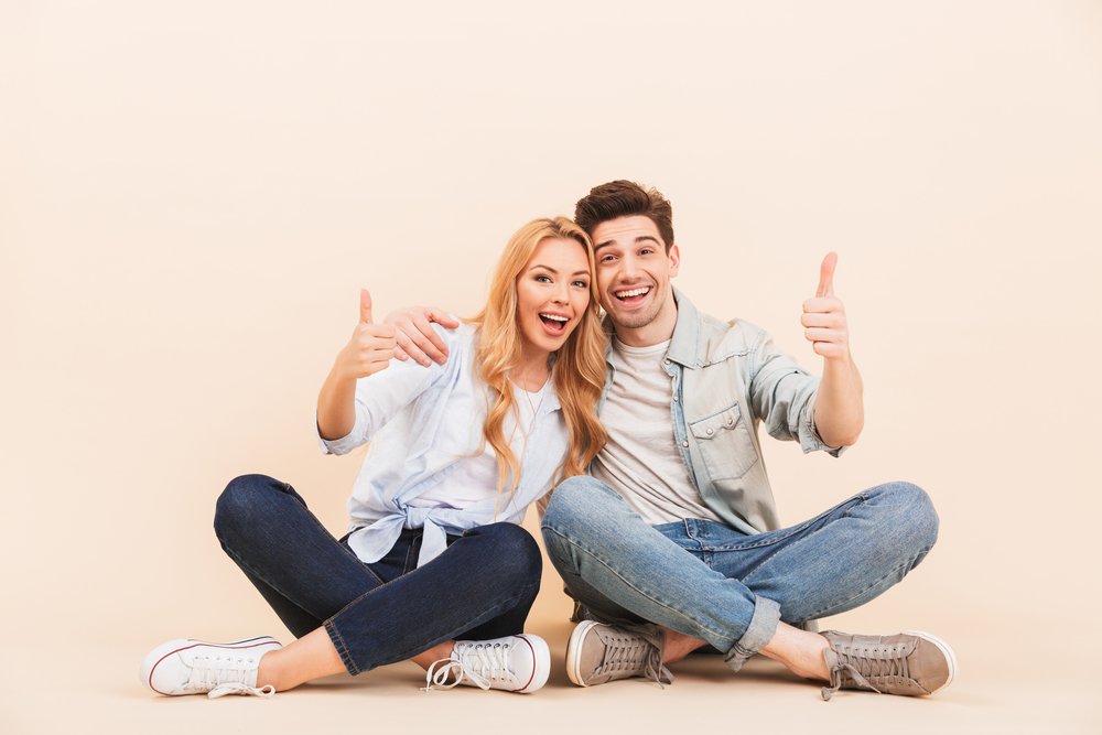 Image of handsome man and beautiful woman hugging together while
